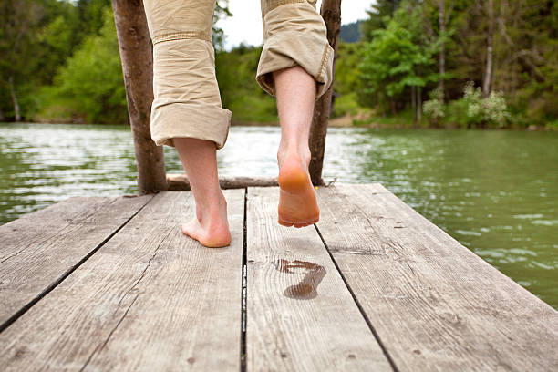 istock footprint on wooden pier 2230705304