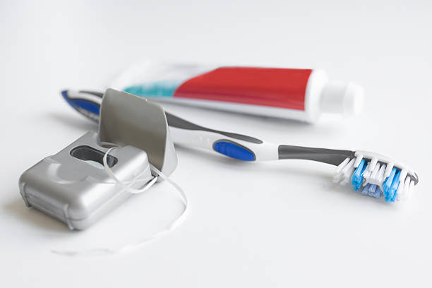 Cropped shot of a woman putting toothpaste on a toothbrush
