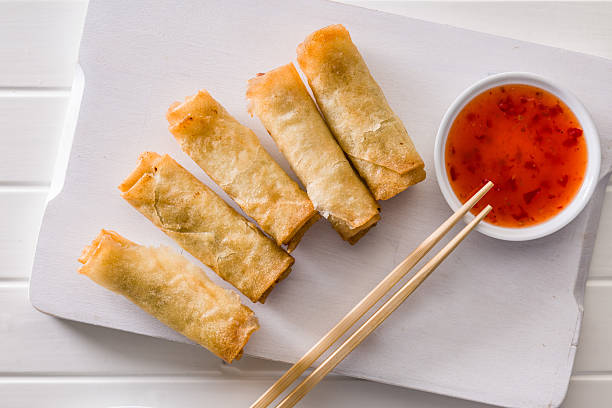 istock Fried spring rolls with sweet and saur sauce on white table. 2230708413