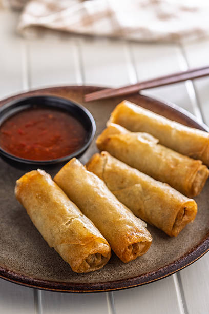 istock Fried spring rolls with sweet and saur sauce on white table. 2230708523