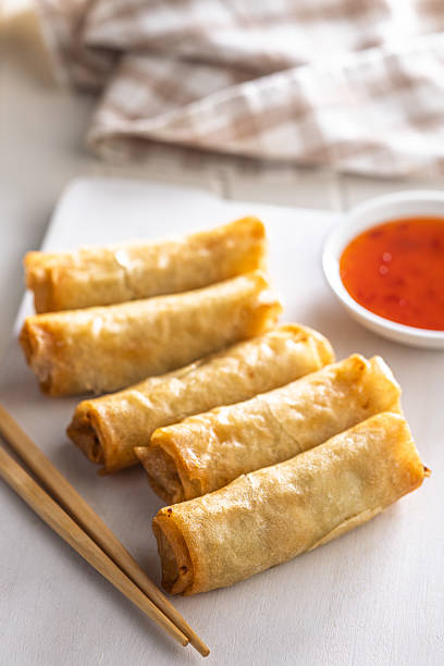 istock Fried spring rolls with sweet and saur sauce on white table. 2230708569