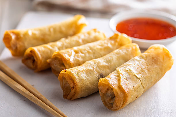 istock Fried spring rolls with sweet and saur sauce on white table. 2230708571