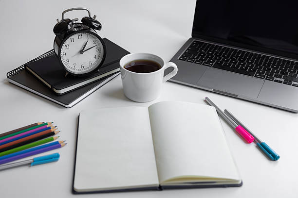 Workspace with blank, office supplies, laptop, pens and hot black coffee cup on table