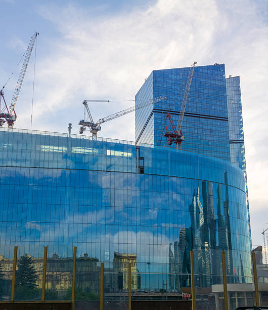 istock modern building with glass walls under construction in the blue sky background 2230710100