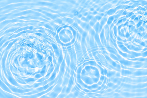 istock Blue water surface with soft ripple waves and sunlight reflections, abstract background for spa, relaxation, purity, freshness, wellness, clean nature concept, and design template. 2230711741