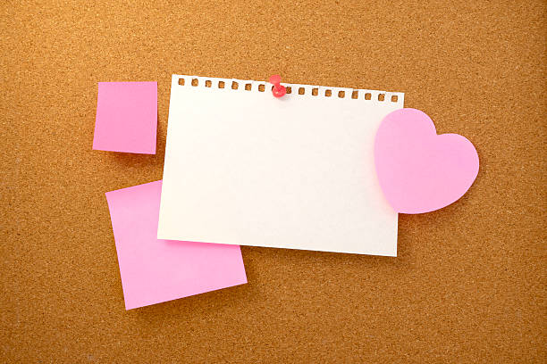 istock Heart shaped note and paper note on brown cork board texture background 2230712011