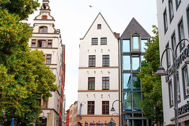 Cologne, Germany - June 15, 2025: Architectural mix of historical and contemporary buildings in Cologne, featuring distinctive facades and urban greenery.