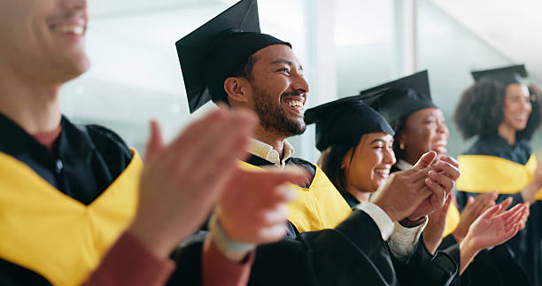 istock Ceremony, clapping and students with celebration, graduation and cheering with achievement. University, women and happy men with success, applause and smile with goals, education or qualification 2230712632