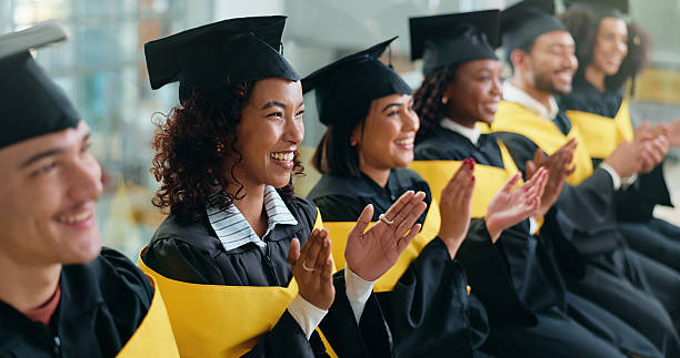 istock Happy people, students or graduation with applause in celebration for qualification or ceremony. Excited group, friends or graduates clapping with smile for achievement, education or scholarship 2230712634