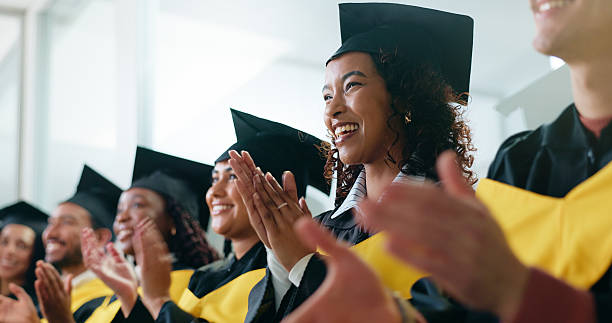 istock University, applause and students with celebration, graduation and smile with achievement. People, women and men with success, clapping and cheering with goals, higher education or college with event 2230712639