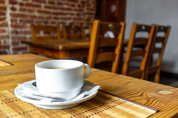 Fine Cup of Coffee on Wooden Table with Napkin Spoon and Sugar in Mir Karelichy District Hrodna Region Belarus.