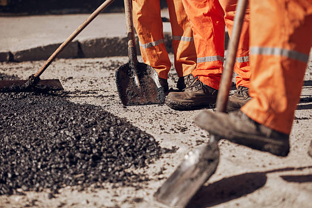istock Construction workers working on a new asphalt layer on a public street. 2230715097