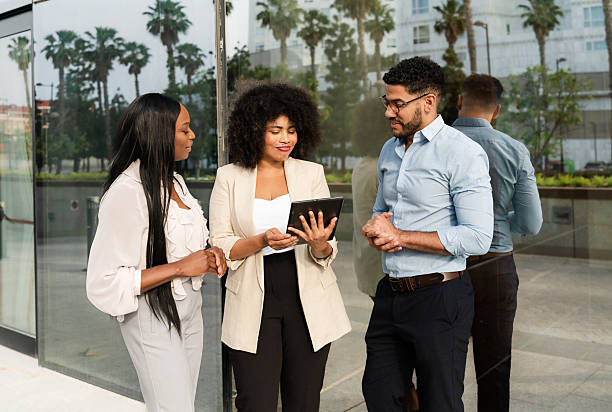 istock Multiracial diverse business team using a digital tablet discussing a project outside office 2230716146
