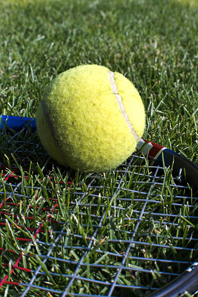 istock Racket and ball for playing tennis on grass. 2230720262