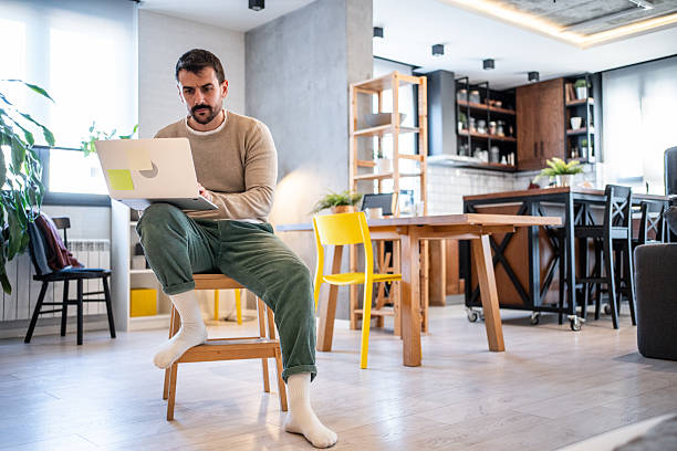istock Focused freelancer working from home on laptop in modern apartment 2230721652