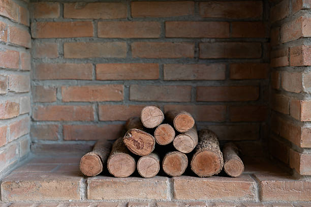 Stack of cut firewood logs piled together in natural wooden texture
