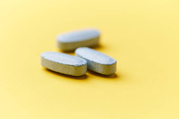 istock Multivitamin tablets on bright paper background. Close up. Copy space. 2230722891