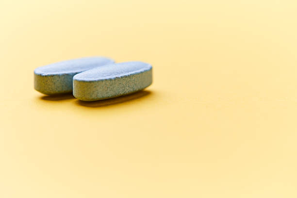 istock Multivitamin tablets on bright paper background. Close up. Copy space. 2230722931