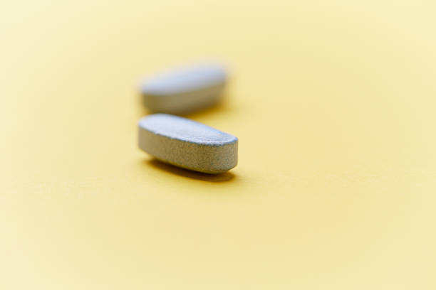 istock Multivitamin tablets on bright paper background. Close up. Copy space. 2230723457
