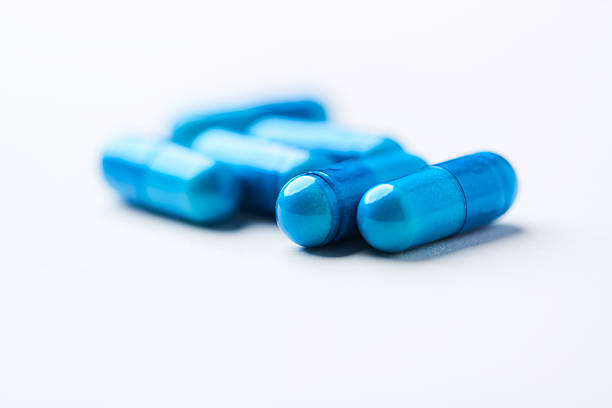 Omeprazole capsules blue and white grouped on white background