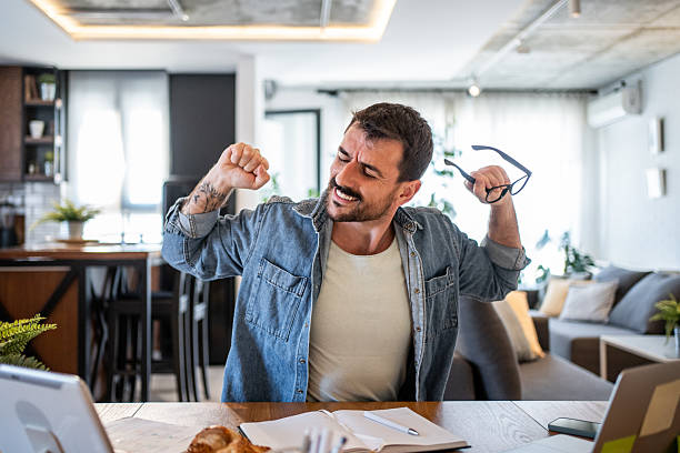 istock Freelancer stretching at home office desk after work 2230723931