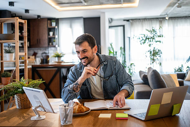 istock Smiling freelancer working from home having a video call on his tablet 2230724014