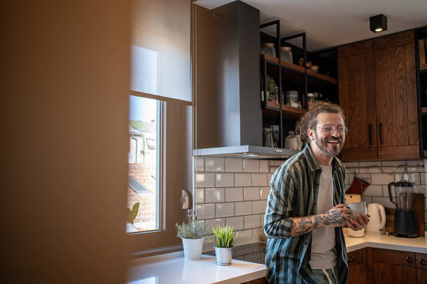 istock Smiling man enjoying a cup of coffee in his modern kitchen 2230724211