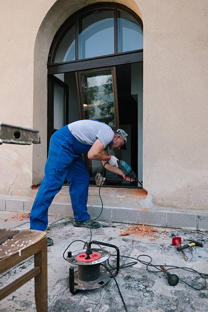 istock Renovation work on a historic villa: A craftsman prepares to replace an exterior sheet metal window sill. 2230724849