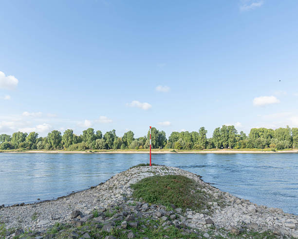 Calm river water flows through dutch countryside at dusk, creating a peaceful scene