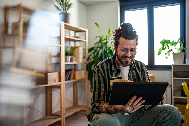 istock Smiling freelancer making online payment using tablet and credit card at home 2230726343
