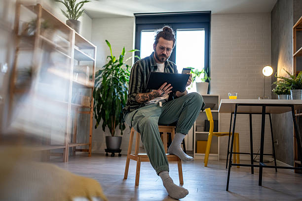 istock Freelancer working from home on tablet and holding credit card 2230726399