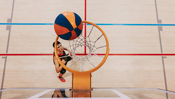 istock Eyes on the prize: Female player aims for the hoop with determination 2230726476