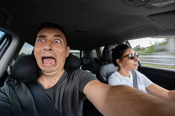 istock Terrified man taking selfie while woman driving recklessly 2230726477