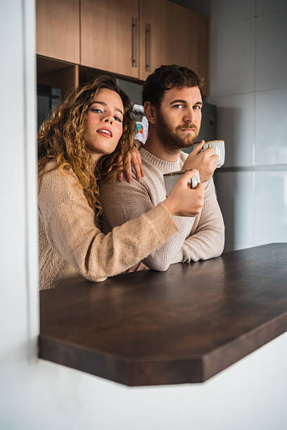 istock Young couple enjoying morning coffee in kitchen 2230726492