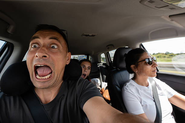 istock Terrified family screaming while driving in car during road trip 2230726512