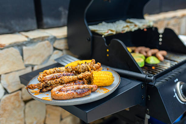 istock Grilled sausages, skewers, and corn on a plate 2230726535