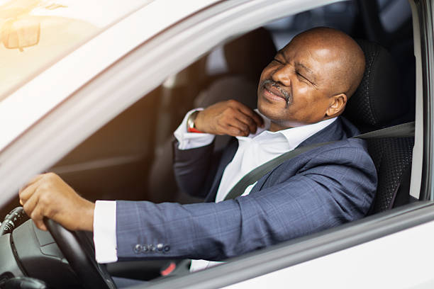 istock Stressed African American businessman sitting in car adjusting collar while driving 2230731680