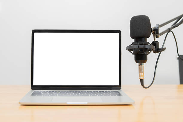 istock Studio Microphone Recording Podcast Audio nearby laptop with isolate screen on table. 2230738580