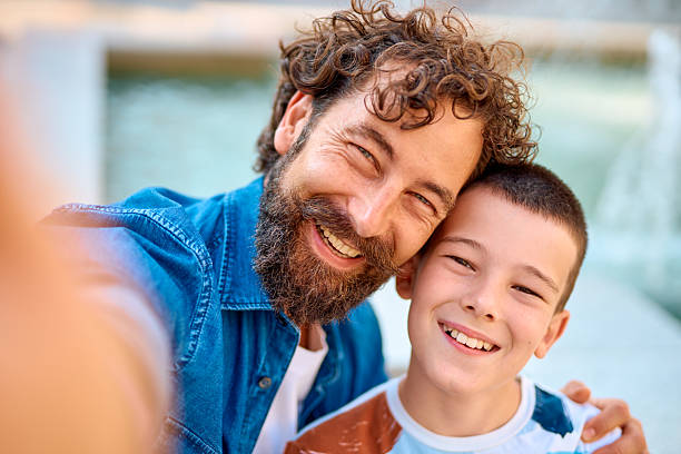istock Father and son taking a selfie and smiling 2230739414