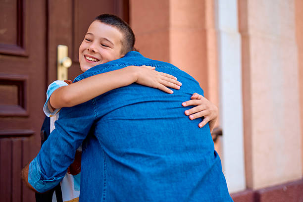 istock Happy son hugging his father after school 2230739487