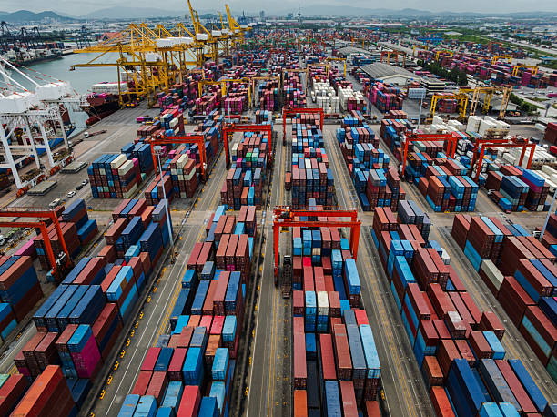 istock shipping logistic, commercial port load and unloading cargo from container ship import and export by crane for distributing goods by trailers transported to customers and dealers 2230739844