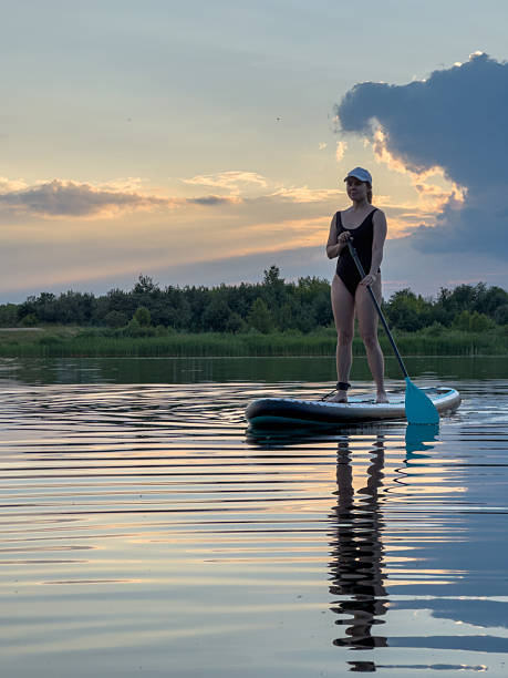 istock Paddleboarding at Sunset on a Tranquil Lake 2230740655