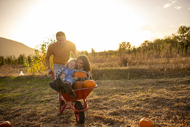 istock Family enjoying autumn in a pumpking patch 2230742915