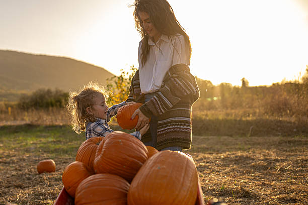 istock Autumn joy with mum in a pumpkin patch 2230743247