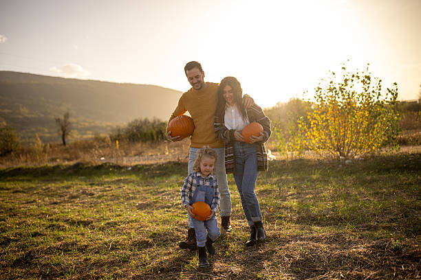 istock Family in a pumpkin patch 2230745926