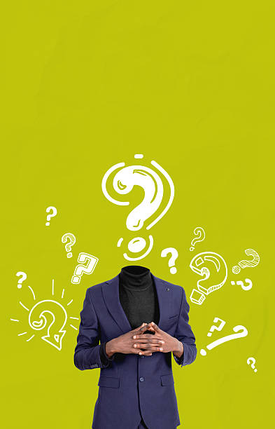 istock Headless man in suit surrounded by question marks on bright gree 2230746537