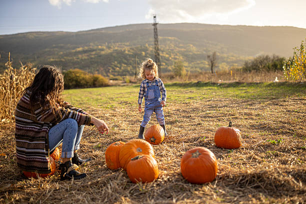 istock Autumn joy with mum in a pumpkin patch 2230747199