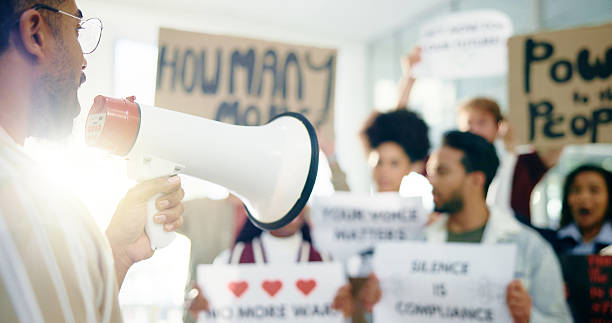 istock Social justice, movement and people with megaphone, opinion or community with protest for awareness. Revolution, group and loudspeaker for announcement of human rights, attention and demonstration 2230757780
