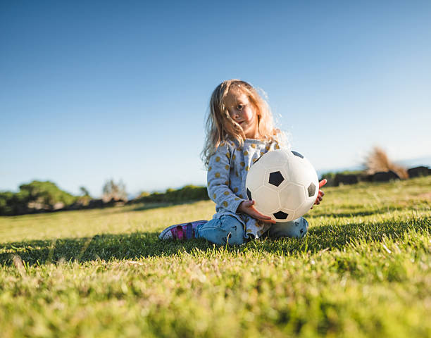 istock little kid playing soccer at the park 2230759431