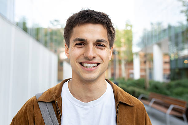 istock Young man smiling at camera in urban setting 2230761807